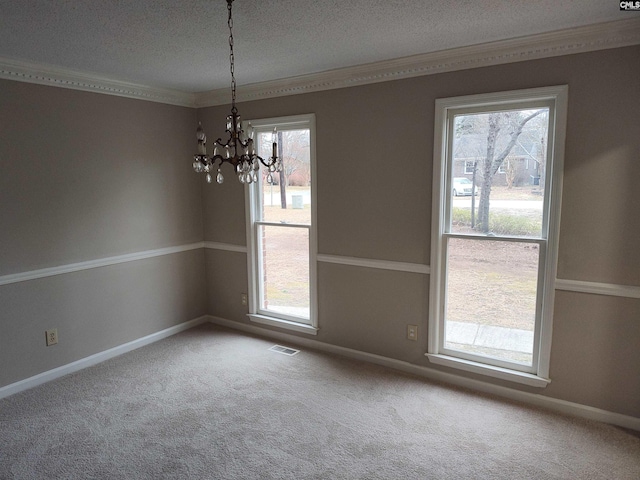 unfurnished room featuring crown molding, a wealth of natural light, and carpet floors