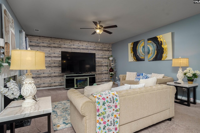 carpeted living room featuring ceiling fan