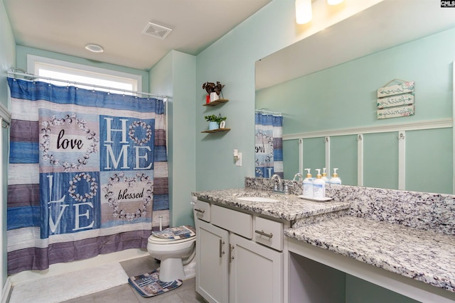 bathroom featuring vanity, a shower with curtain, tile patterned floors, and toilet