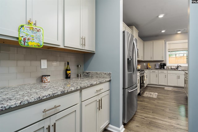 kitchen with white cabinets and light stone counters