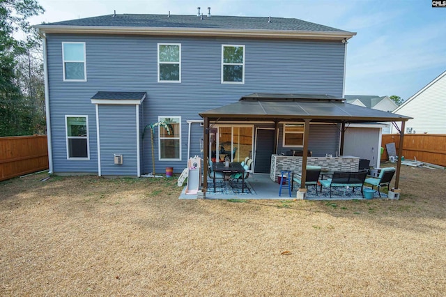 back of house with a yard and a patio