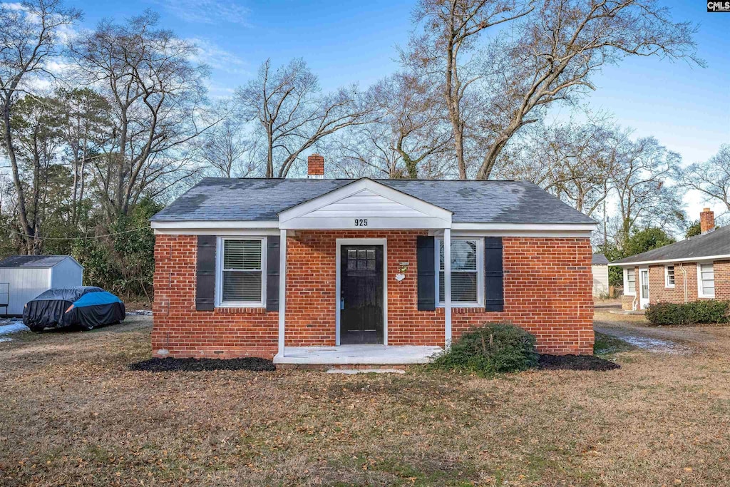 bungalow-style house with a front lawn