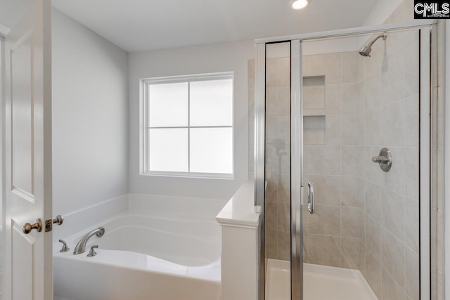 bathroom featuring separate shower and tub