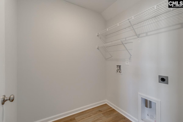 laundry room with hookup for a washing machine, electric dryer hookup, and hardwood / wood-style floors