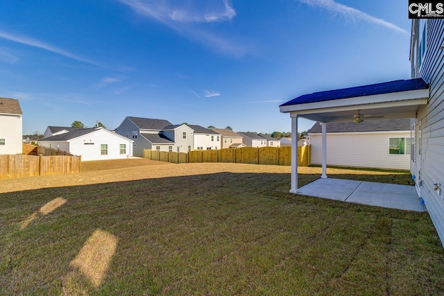 view of yard with a patio area and ceiling fan