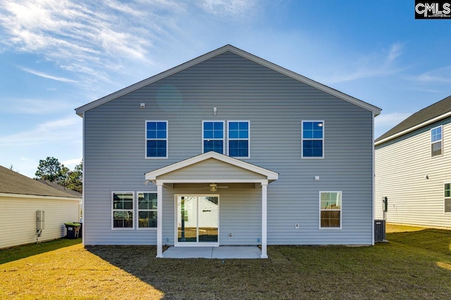 rear view of property featuring a yard, a patio area, and ceiling fan