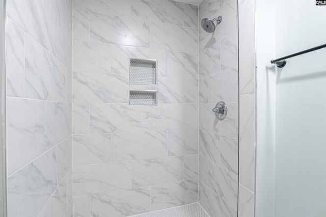 bathroom with tiled shower