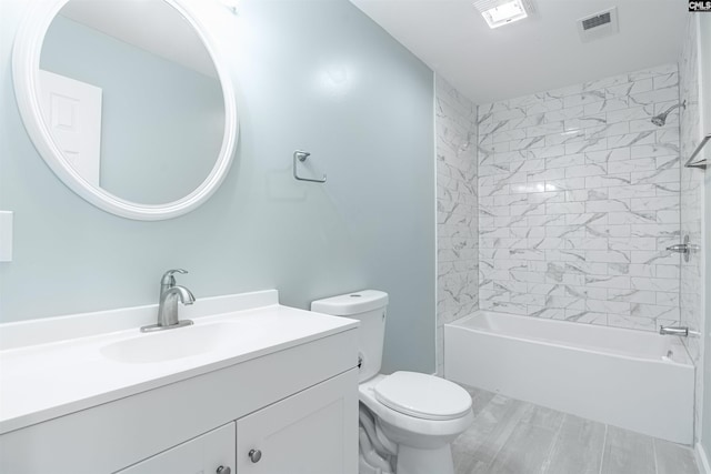 full bathroom with tiled shower / bath combo, vanity, and toilet