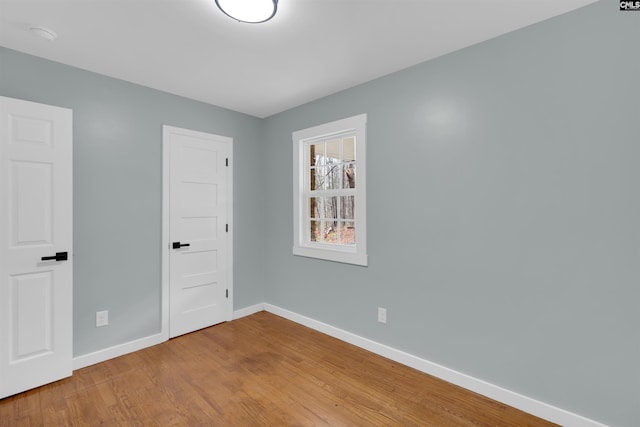 unfurnished room featuring hardwood / wood-style flooring