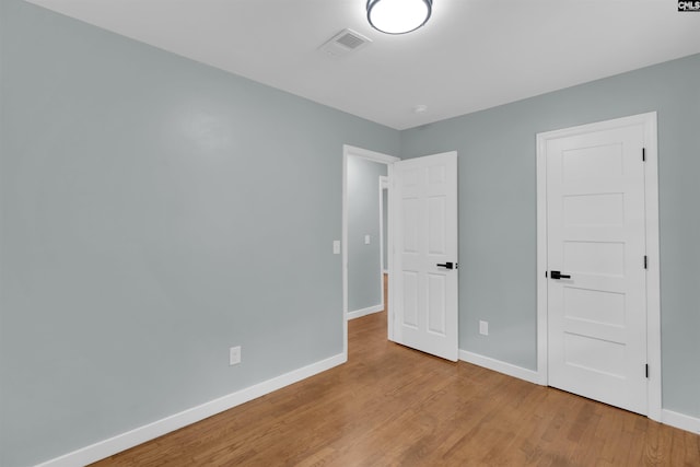 unfurnished bedroom with light wood-type flooring