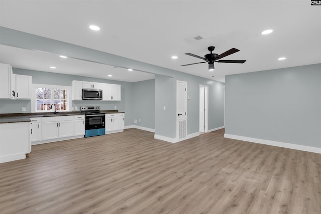 kitchen featuring sink, light hardwood / wood-style flooring, ceiling fan, stainless steel appliances, and white cabinets