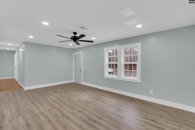 spare room with ceiling fan and light wood-type flooring