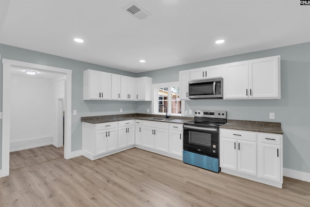 kitchen with white cabinetry, appliances with stainless steel finishes, sink, and light wood-type flooring