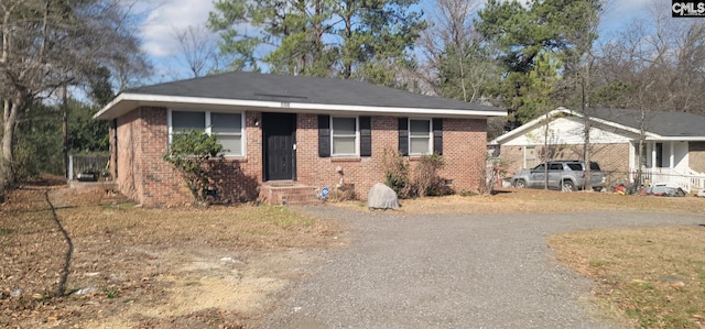 view of front of home with aphalt driveway, a carport, and brick siding