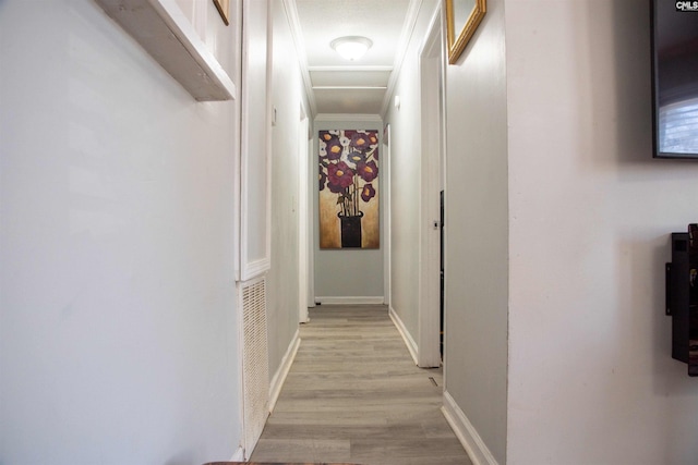 hall featuring light wood-style floors and baseboards