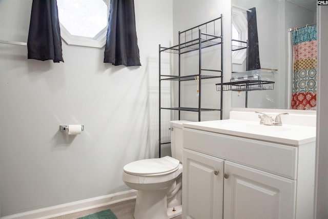 bathroom with toilet, wood finished floors, vanity, baseboards, and a shower with curtain