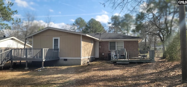 rear view of house with a deck and crawl space