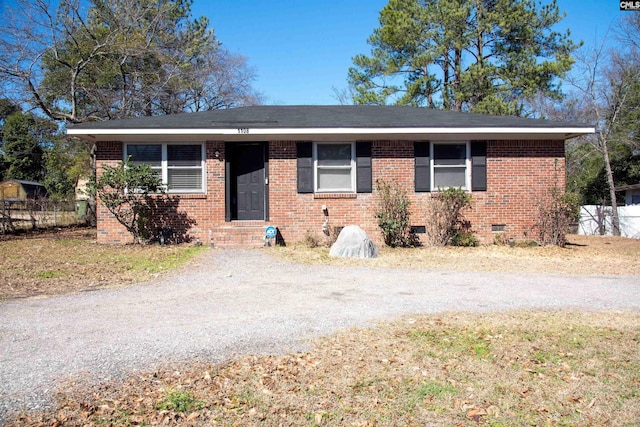 ranch-style home with driveway, brick siding, crawl space, and fence