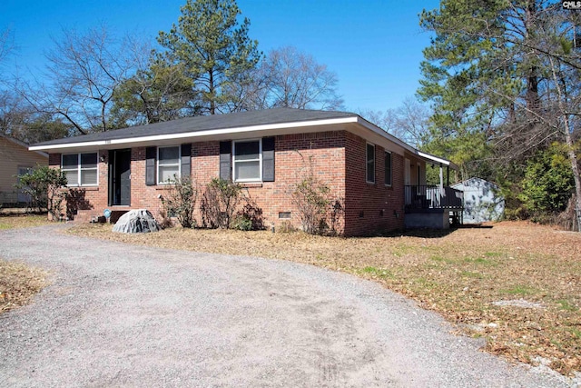 view of front facade featuring crawl space and brick siding