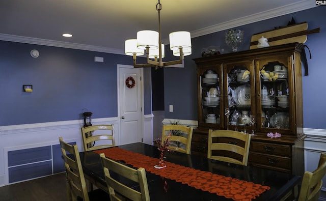 dining area with crown molding, dark hardwood / wood-style floors, and a chandelier