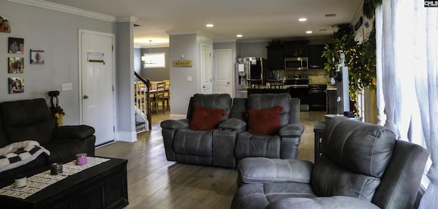 living room with ornamental molding and dark hardwood / wood-style floors