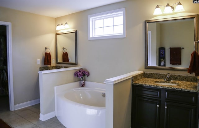 bathroom featuring vanity, a bath, and tile patterned floors