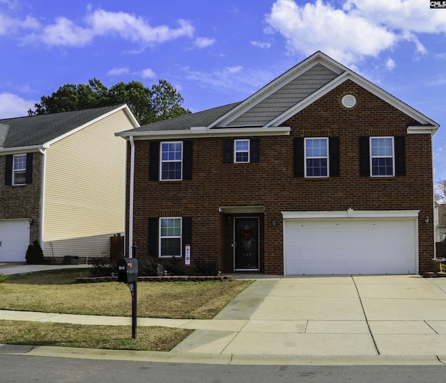 view of front of property with a garage and a front yard