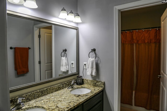 bathroom featuring vanity and curtained shower