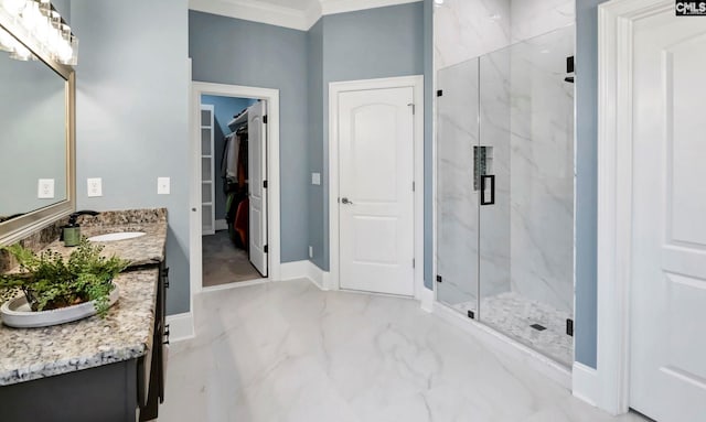 bathroom featuring crown molding, vanity, and walk in shower