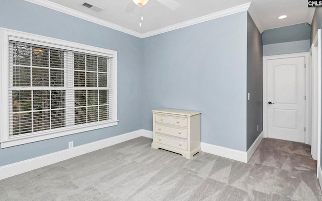 empty room with crown molding, light carpet, and ceiling fan