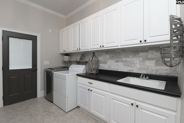 laundry room featuring light tile patterned flooring, sink, crown molding, cabinets, and washer and clothes dryer