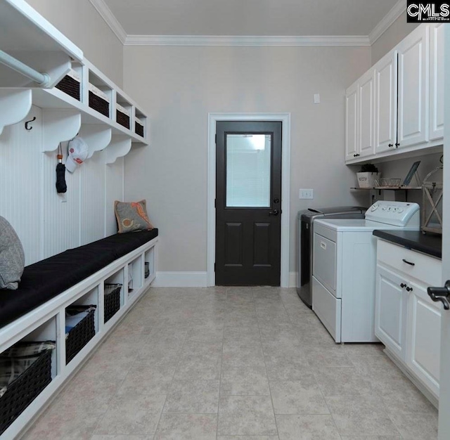 laundry area with separate washer and dryer, crown molding, and cabinets