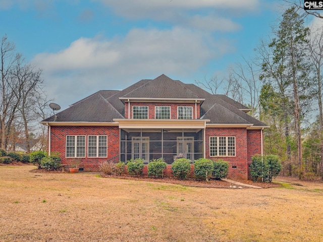 back of house featuring a sunroom and a yard