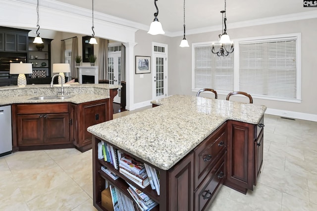 kitchen with sink, decorative light fixtures, and a center island