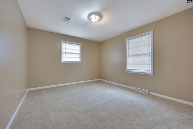 spare room with light colored carpet