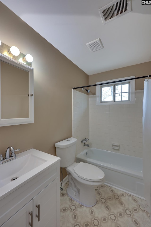 full bathroom with tiled shower / bath combo, vanity, tile patterned floors, and toilet