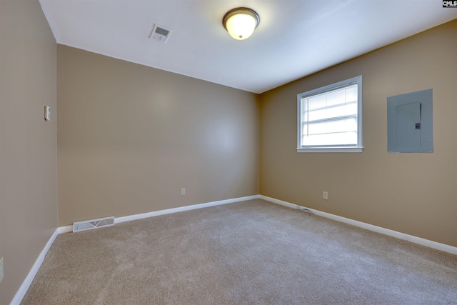 carpeted empty room with electric panel