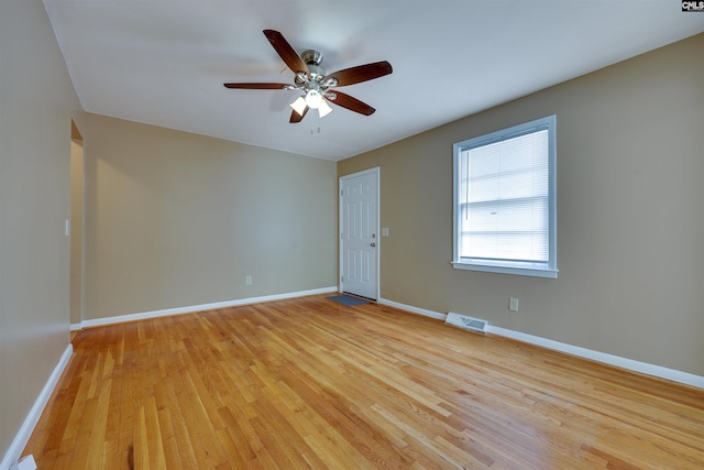 spare room with ceiling fan and light wood-type flooring