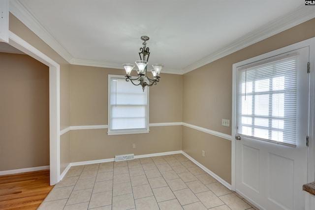 unfurnished dining area with an inviting chandelier and crown molding