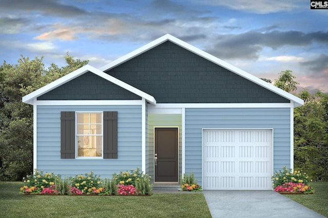 view of front of home with a garage and a lawn