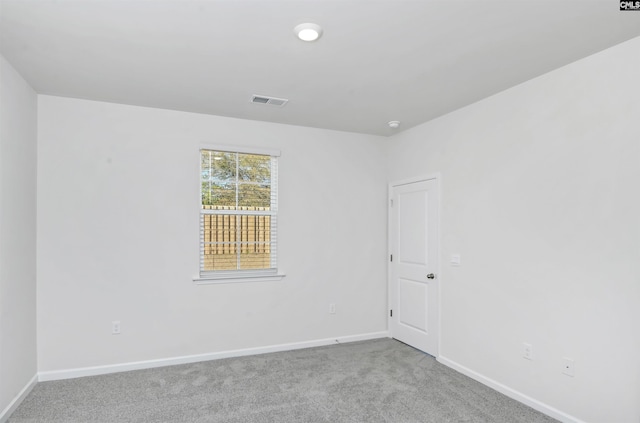 unfurnished room with light carpet