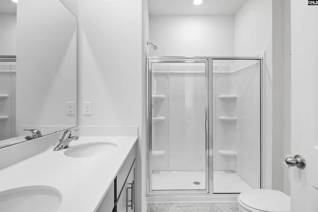 bathroom with toilet, vanity, and walk in shower