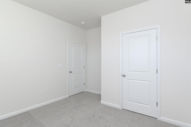 unfurnished bedroom featuring light colored carpet