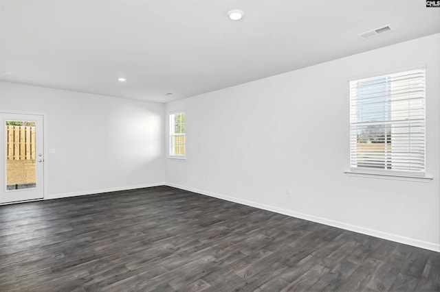 unfurnished room featuring dark hardwood / wood-style flooring