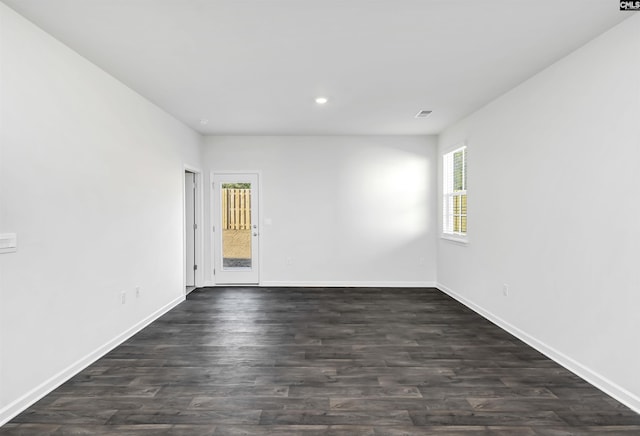 unfurnished room featuring dark hardwood / wood-style flooring