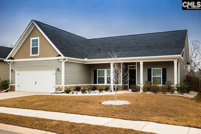 craftsman inspired home featuring a porch, a garage, and a front yard