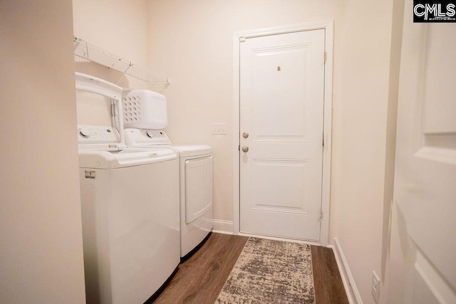 laundry room with dark hardwood / wood-style flooring and independent washer and dryer