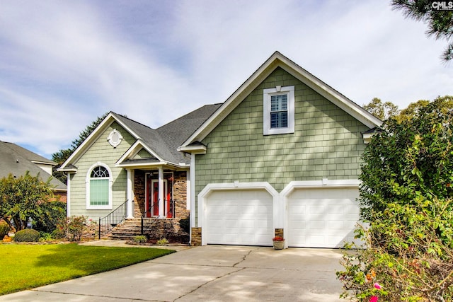 view of front of property with a garage and a front lawn