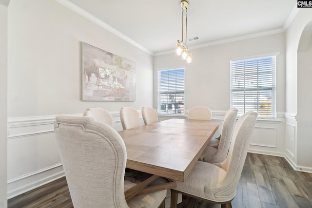 dining area featuring crown molding, a wealth of natural light, and dark wood-type flooring