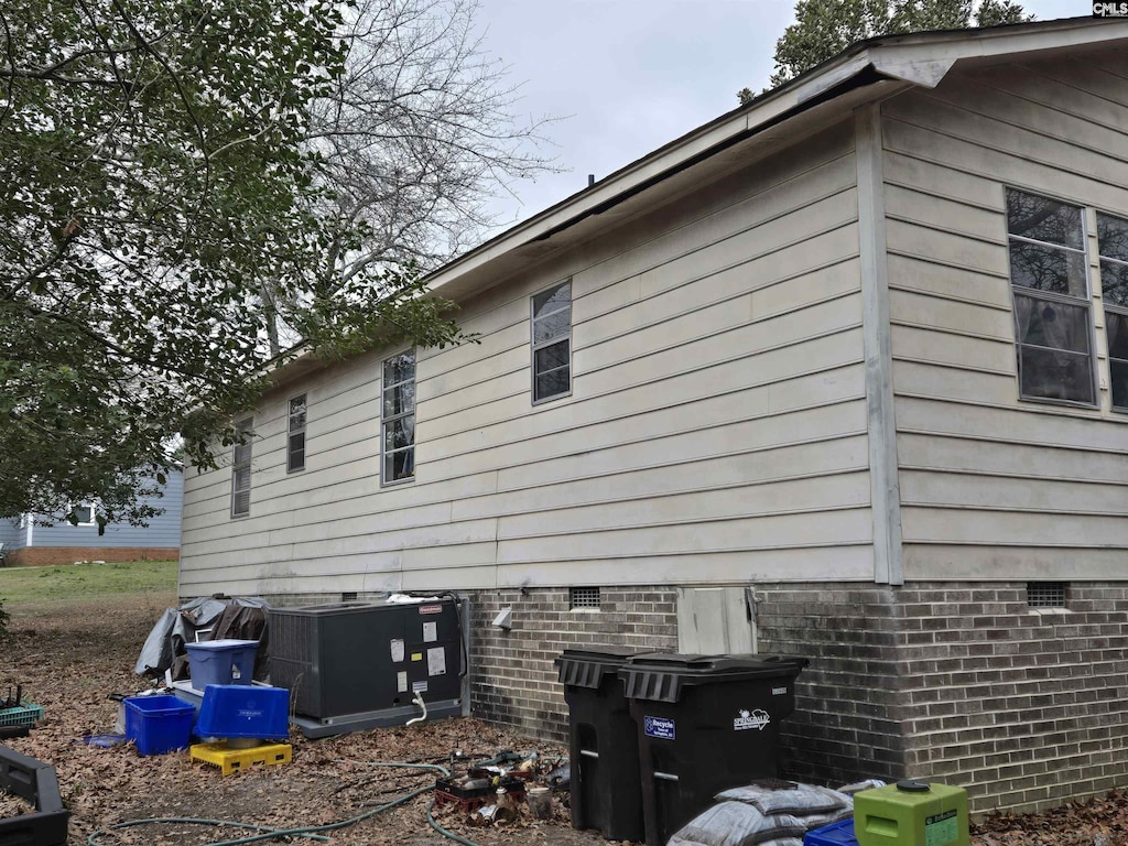 view of side of home featuring cooling unit